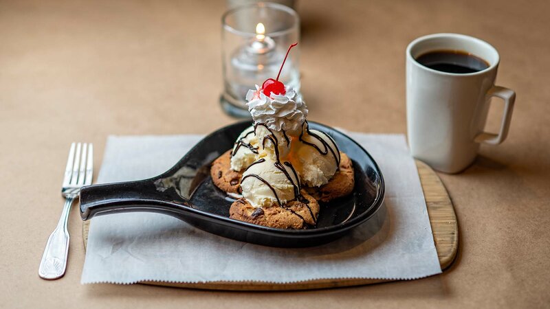 Cookies topped with vanilla ice cream, whipped cream and a cherry on top